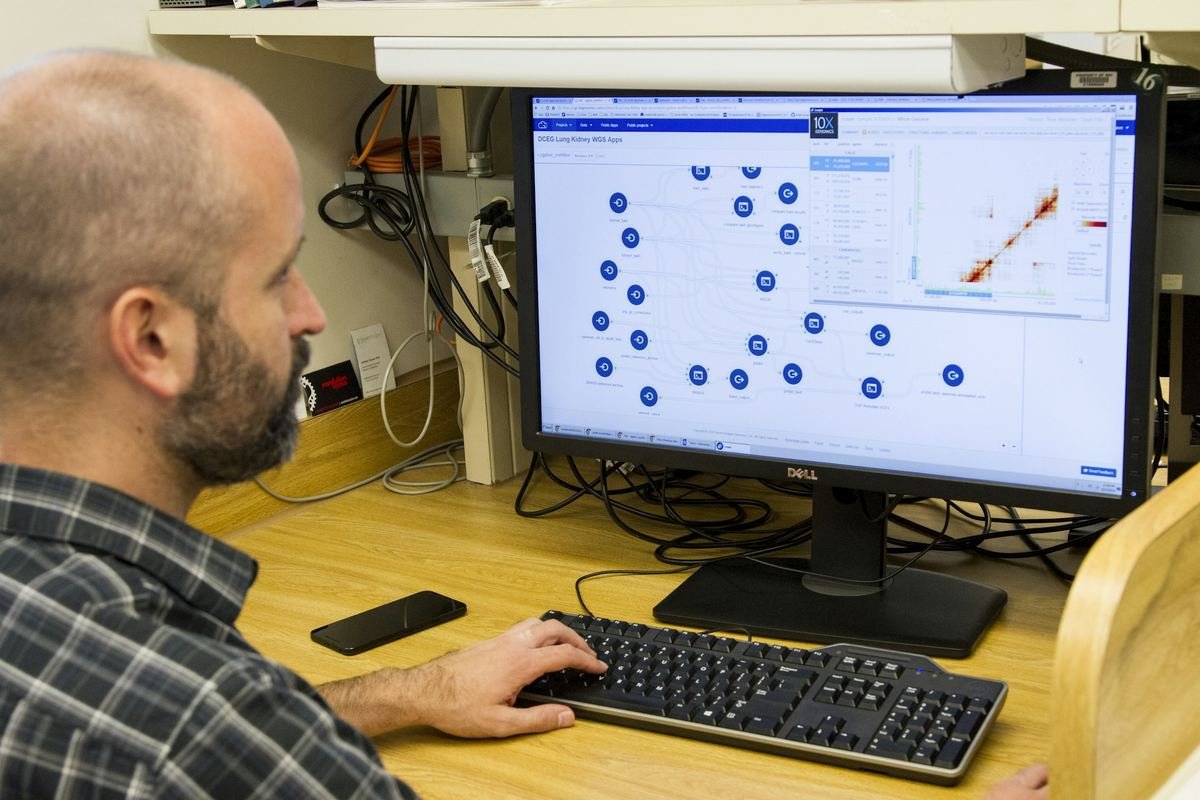 A scientist reviewing genomic data on a computer screen.